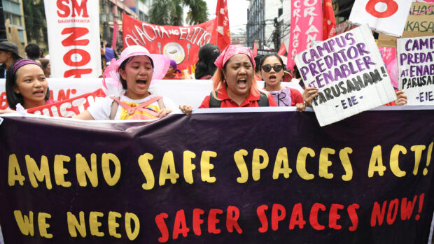 Women activists carrying placards shout slogans during a protest march to the Malacanang Palace to mark International Women's Day in Manila on March 8, 2024. They also protest violence against women.
