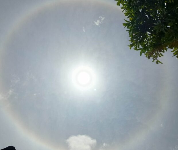 A sun halo, which is called "mariyes" in Batanes, appears in the skyline of Itbayat town on Tuesday (April 2)