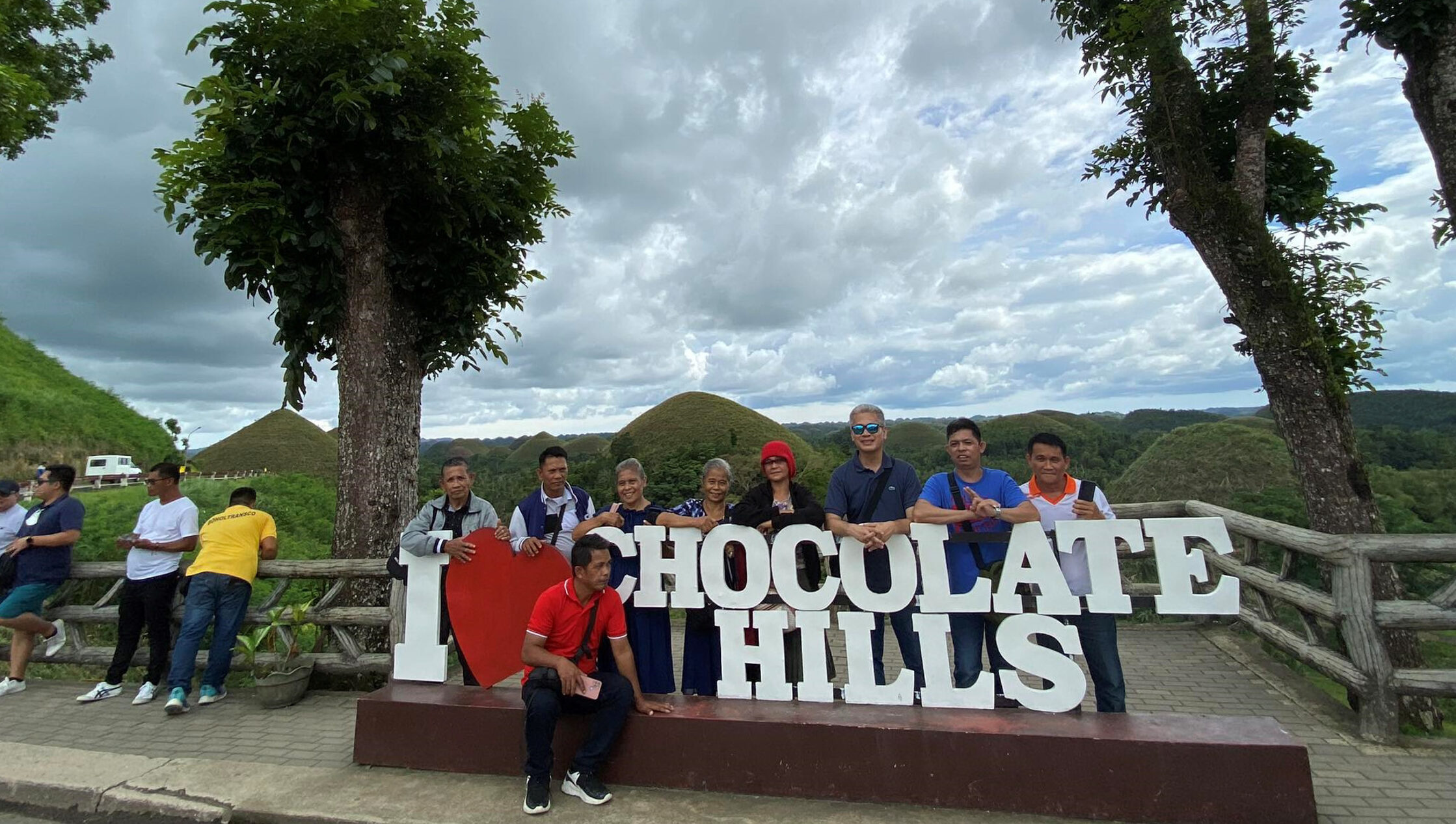 Tourists pose for a photo of the Chocolate Hills