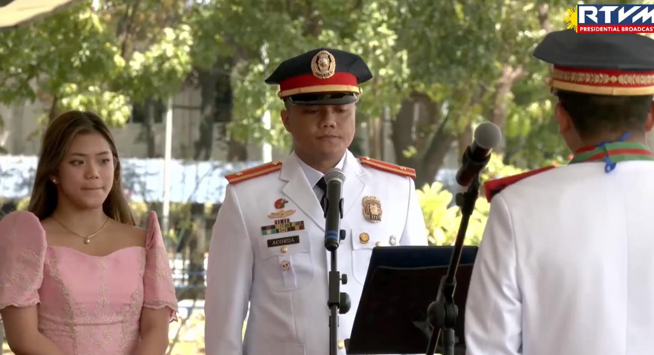 Purification Nicole Acorda (left) and Benjamin Acorda III (right) read the Retirement of the Badge before their father former PNP chief Gen. Benjamin Acorda Jr. during the command conference ceremony held at Camp Crame, Quezon City on Monday, April 1, 2024. (Photo courtesy of RTVM)