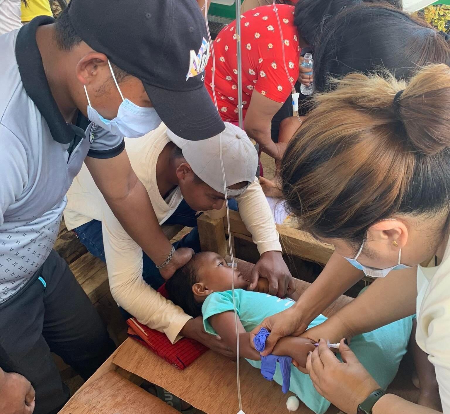 Health workers from Rural Health Unit of the South Upi local government take care of a child who felt sick after attending a tribal wedding on Thursday.