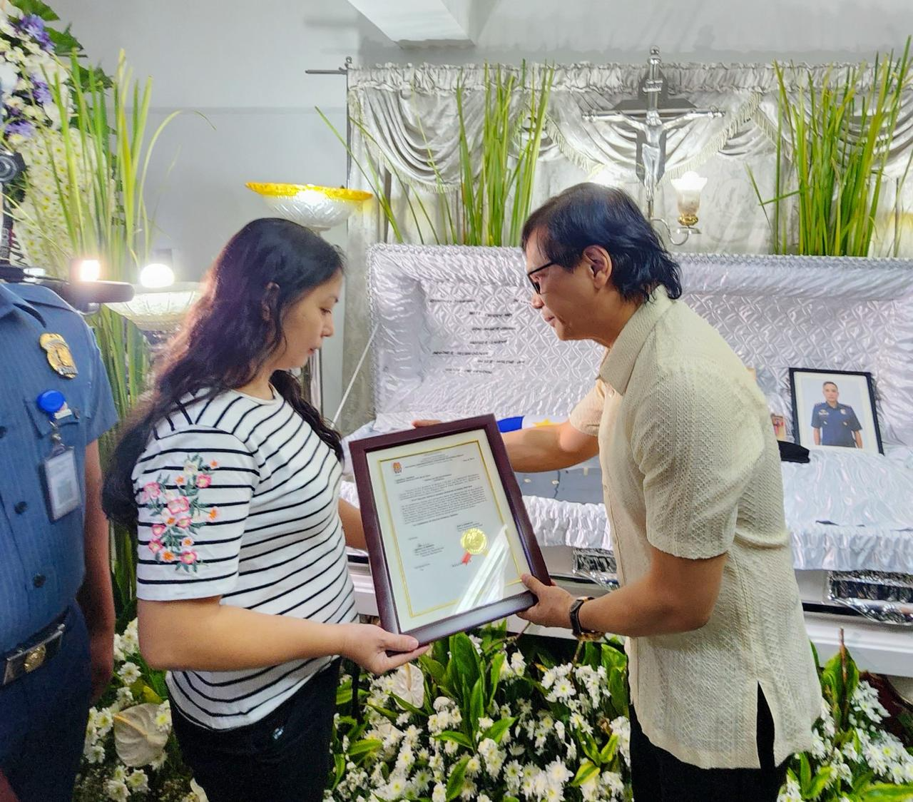 Interior Secretary Benhur Abacus gives posthumous honors to the family of Ronald Moralde, a police officer who was slain while confronting an armed man. Photo from the Office of Secretary of Interior and Local Government Benhur Abalos