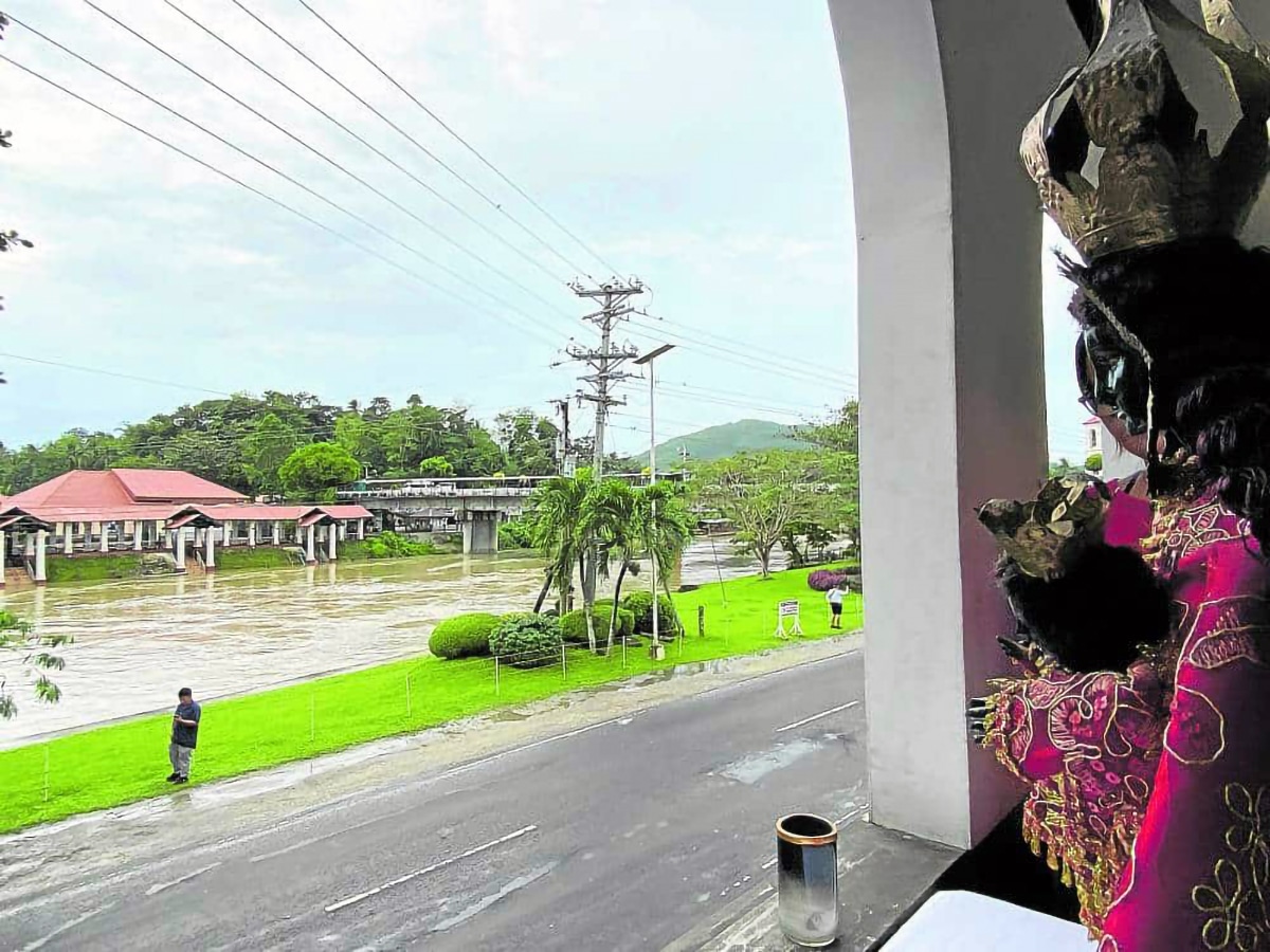 PRAYERS FOR SAFETY An image of theOur Lady of Guadalupede Extremadura is displayed in front of the Loboc River in Loboc, Bohol, in a practice called “dungaw” (to look out) to seek the patroness’ intercession to calm the swollen river on Jan. 12, 2023.