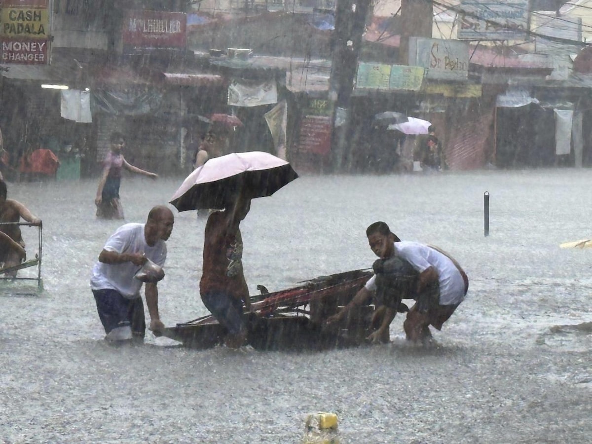PHOTO: People wading in a flooded street in Metro Manila