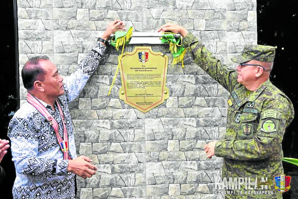OPEN TO THE PUBLICUndersecretary for Bangsamoro Transformation David Diciano (left) and Maj. Gen. Alex Rillera, 6ID commander, unveil a museum marker to signal its opening to the public. 