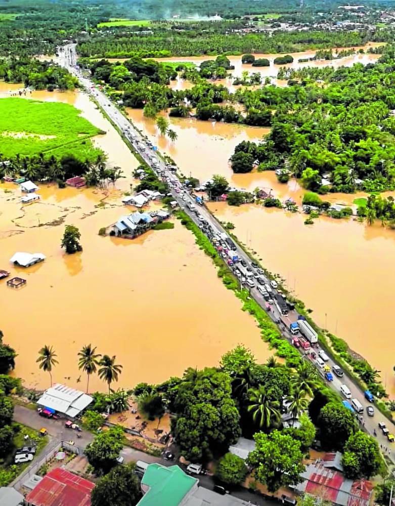 Vehicular traffic stood at a standstill along the national highway in Pagalungan town, Maguindanao del Sur amid rising floodwaters last week. (