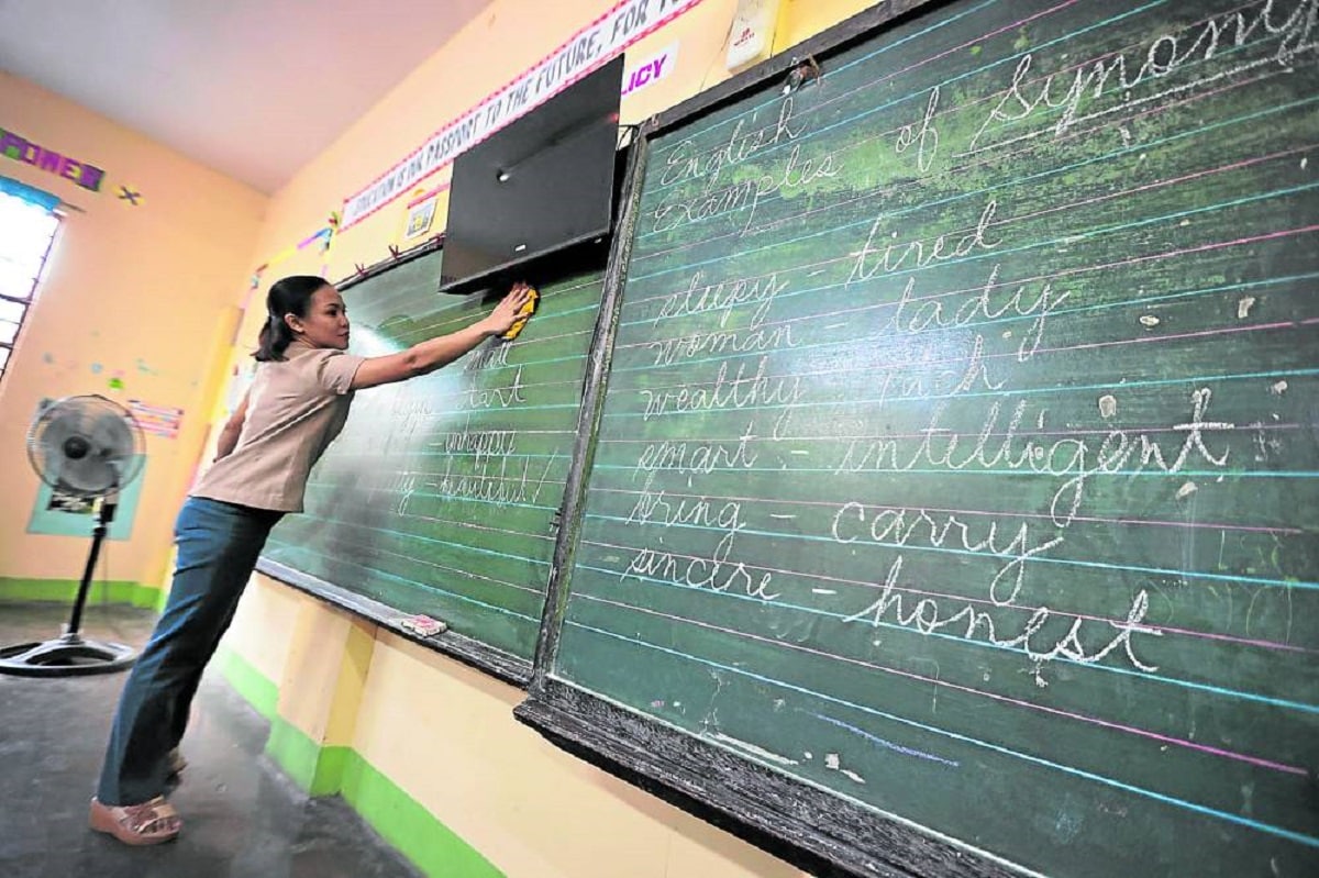 The signing of the implementingrules and regulations for the Department of Education’s career progression policy for teachers was announced three days before the opening of the new academic year on July 29. This file photo of a teacher at San Francisco Elementary School in Quezon was taken on Jan. 31, 2023.