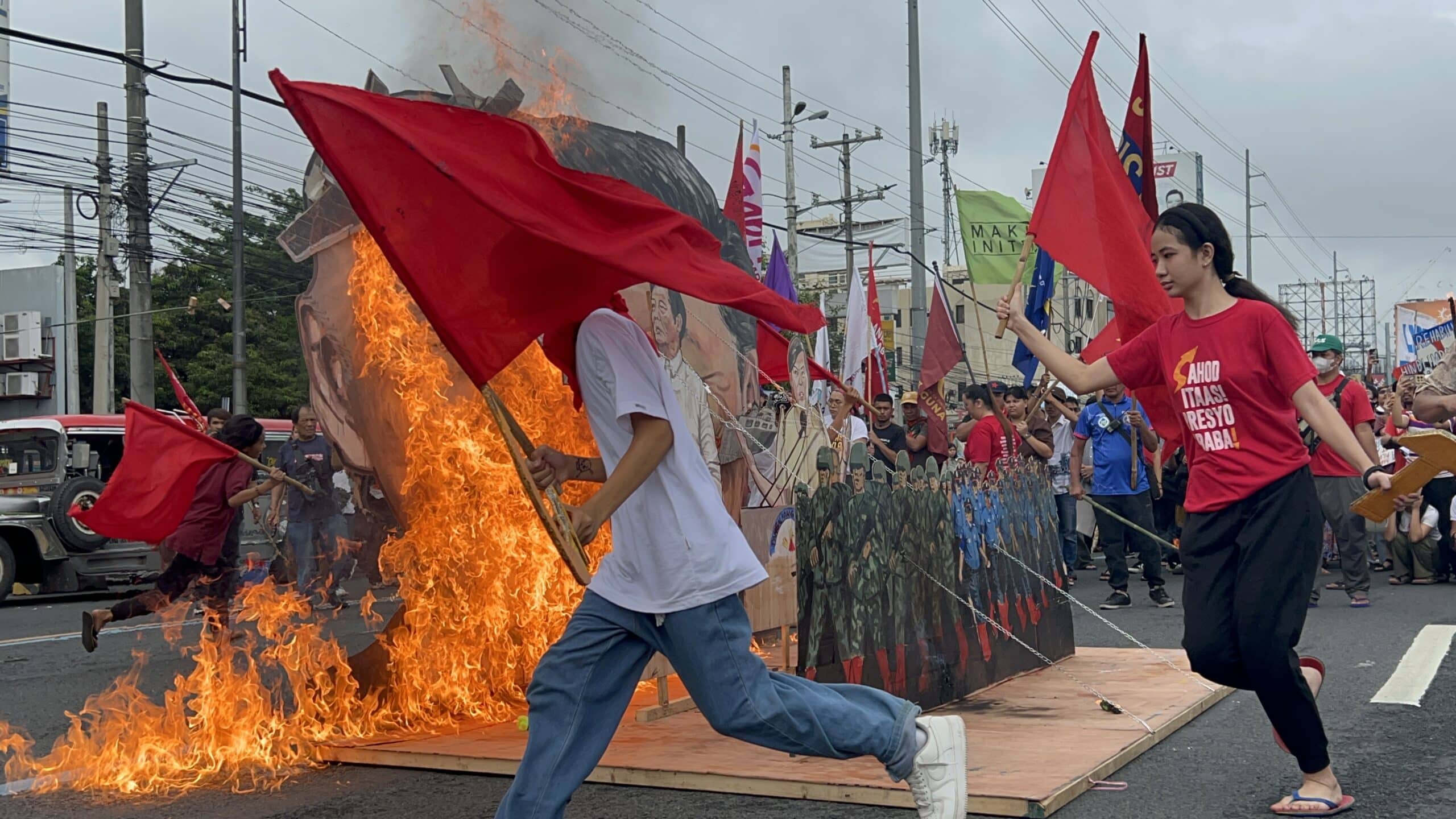 LOOK: Protesters end People’s Sona by burning Marcos-Duterte effigy