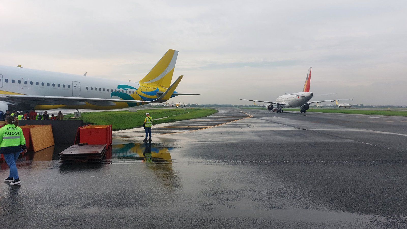 The Manila International Airport Authority says a Cebu Pacific Air A-321 aircraft “slightly swerved” into the grassy portion of the taxiway of the Ninoy Aquino International Airport (Naia) terminal 3 on Friday morning. (Photo courtesy of Miaa)  STORY: Plane gets stuck on grassy part of Naia taxiway, may affect flights
