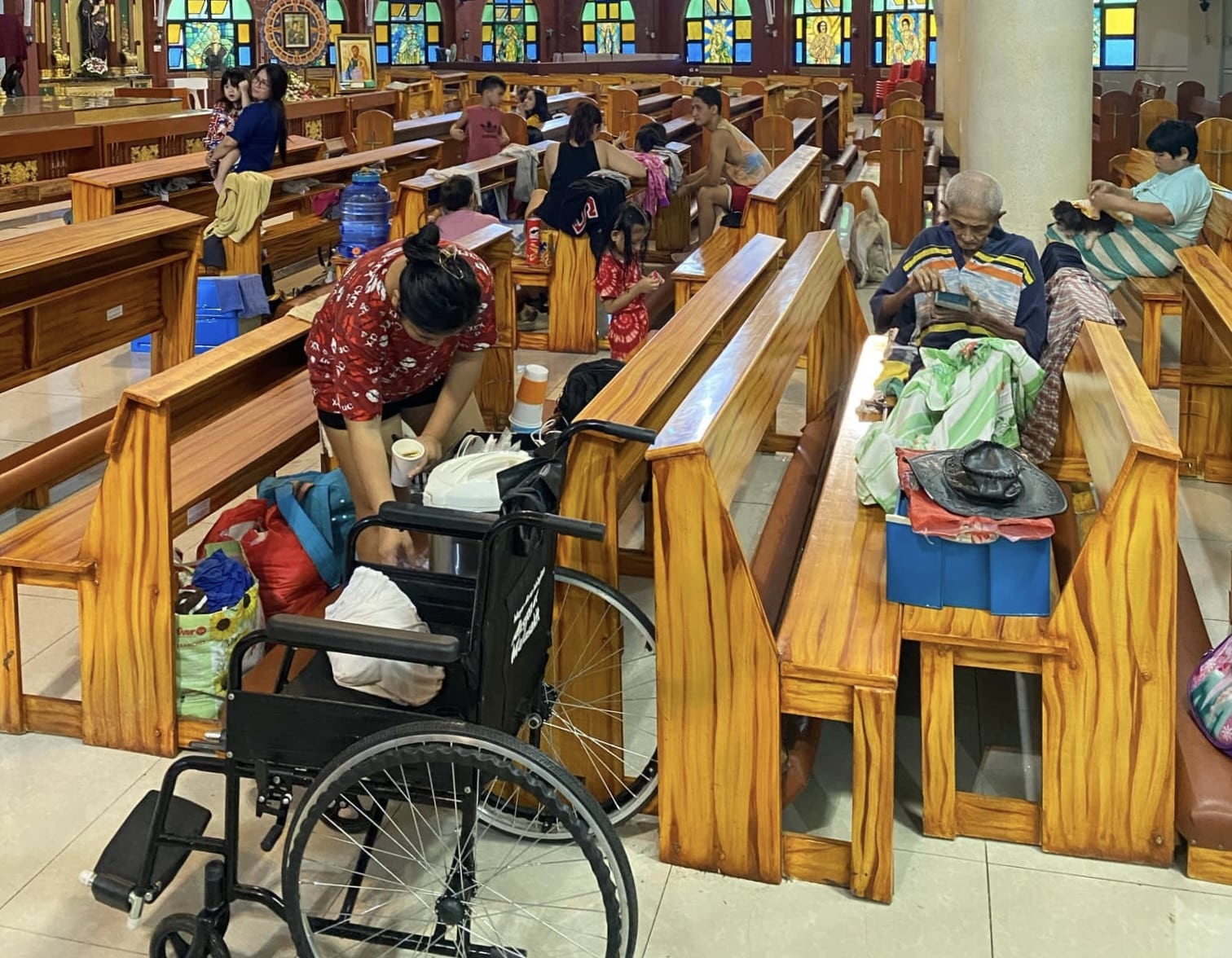 SHELTER. Residents displaced by habagat rains, enhanced by Typhoon Carina, take shelter inside a church in Novaliches, Quezon City.
