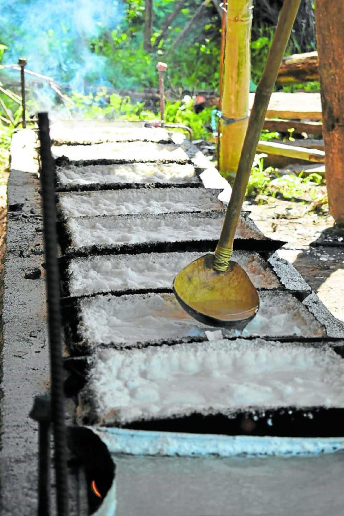 TRADITIONAL PROCESSSalted water is poured into lumps of salt as part of the traditional process which the Padojenog family has preserved for generations.