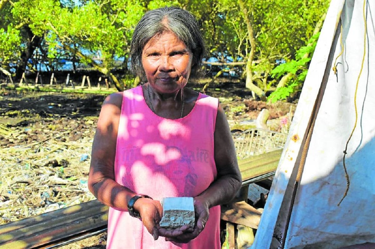 UNIQUE PRODUCT Shirley Padojenog, 65, says this block of “tultul” has sustained their family since her grandfather developedthis unique technique of salt-making in their hometown of Jordan in Guimaras a century ago. Tultul is made from ashes of seawater- soaked driftwood flavored with coconut milk. 