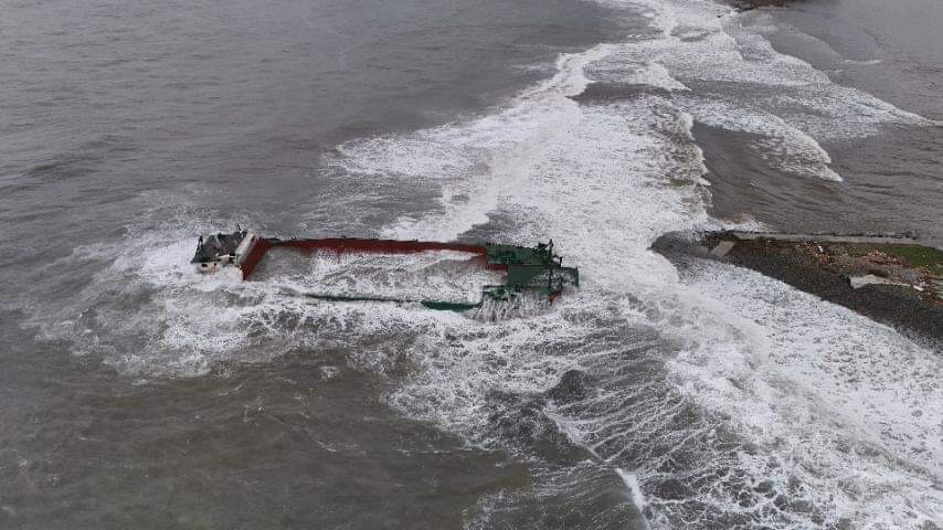 DISTRESSED VESSEL A drone shot taken on July 26 following the onslaught of Supertyphoon “Carina” (Gaemi) shows the submerged foreign vessel Hyperline 998 in the waters off Barangay Malomain San Felipe, Zambales. The Philippine Coast Guard and the owner of an unfinished pier where the ship ran aground are clashing over the removal of the distressed vessel. 