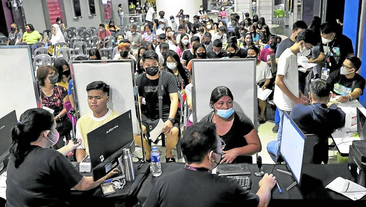 PHOTO: oters register at a Manila shopping mall during a test run in July 2022.