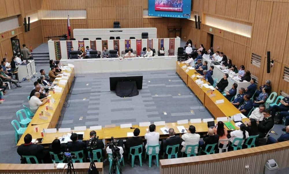 FACE OFF Police officials face off with Kingdom of JesusChrist (KOJC) officers and their lawyers during Friday’s Senate hearing, led by Senators Ronald dela Rosa (center), Robinhood Padilla and Christopher “Bong” Go, at the session hall of the Davao City council (upper left). The hearing was part of the probe of alleged abuses in the police operation to arrest fugitive televangelist and KOJC leader Apollo Quiboloy (right) and four other sect members inside the KOJC compound in Buhangin district that started on Aug. 24.