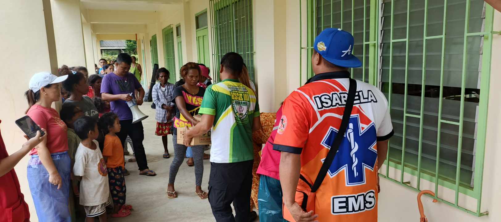 EVACUEES in Palanan, Isabela take instruction from local disaster response officers.