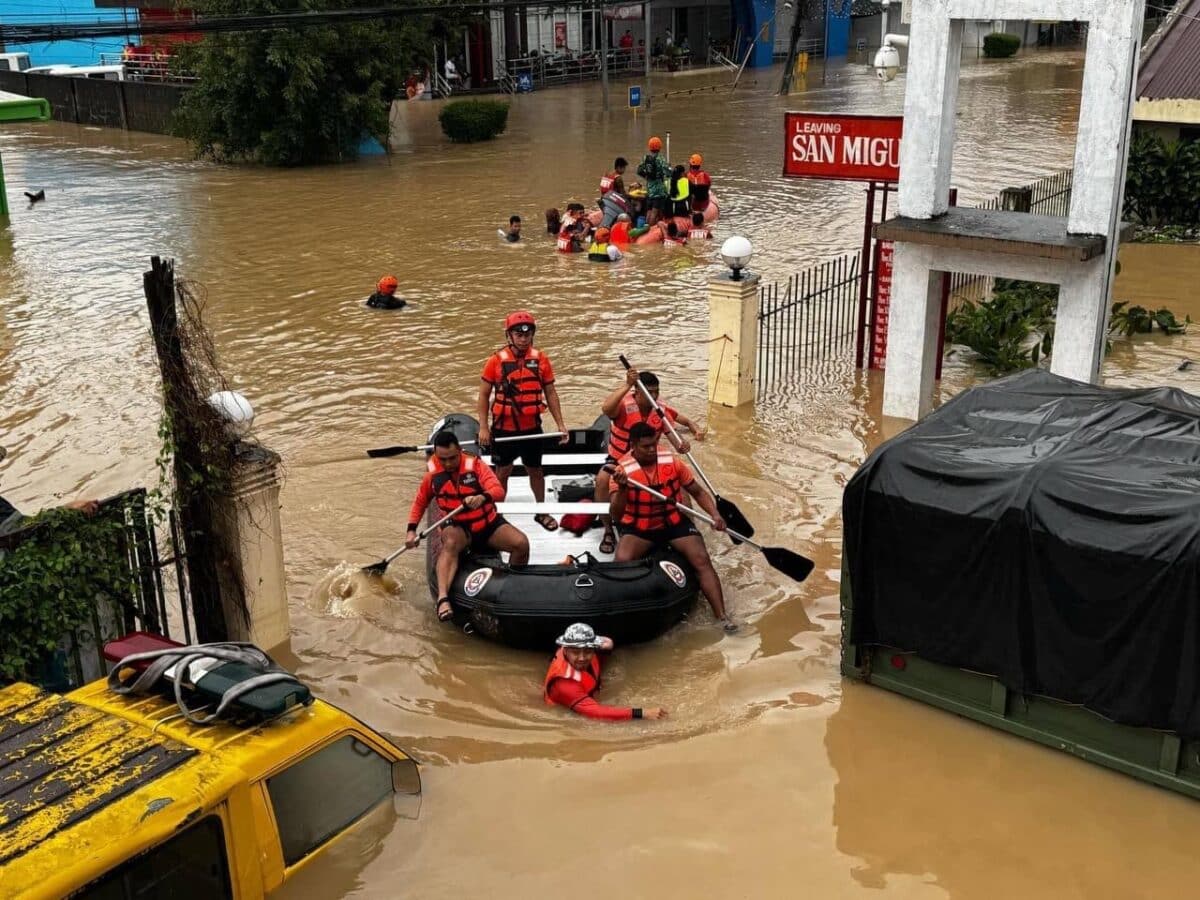 In this handout photo from the Philippine Coast Guard (PCG) taken and received on October 24, 2024, rescuers on a rubber boat conduct a rescue operations in a flooded area in Nabua, Camarines Sur, due to Tropical Storm Trami. (Photo by Handout / Philippine Coast Guard (PCG) / AFP) / -----EDITORS NOTE --- RESTRICTED TO EDITORIAL USE - MANDATORY CREDIT "AFP PHOTO / PHILIPPINE COAST GUARD (PCG) " - NO MARKETING - NO ADVERTISING CAMPAIGNS - DISTRIBUTED AS A SERVICE TO CLIENTS - NO ARCHIVE