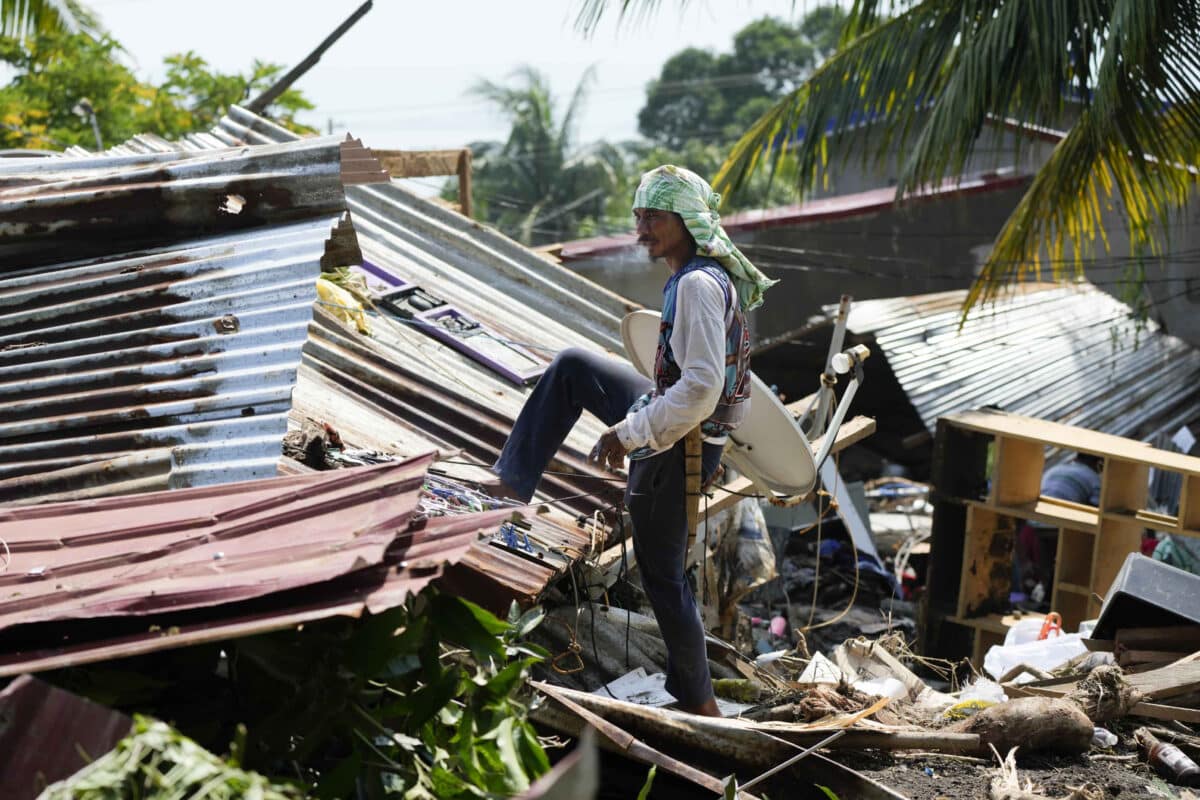 Residents try to recover belongings from their damaged homes after a recent landslide triggered by Tropical Storm Trami struck Talisay, Batangas province, Philippines leaving thousands homeless and several villagers dead on Saturday, Oct. 26, 2024.