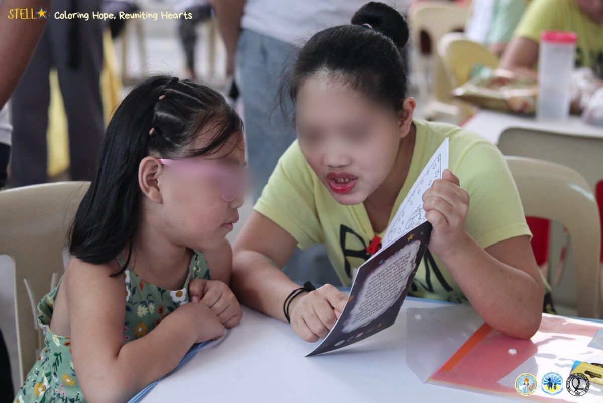 A mother reads the story of “Stella” to her daughter. Photo courtesy of HLAF/Facebook.