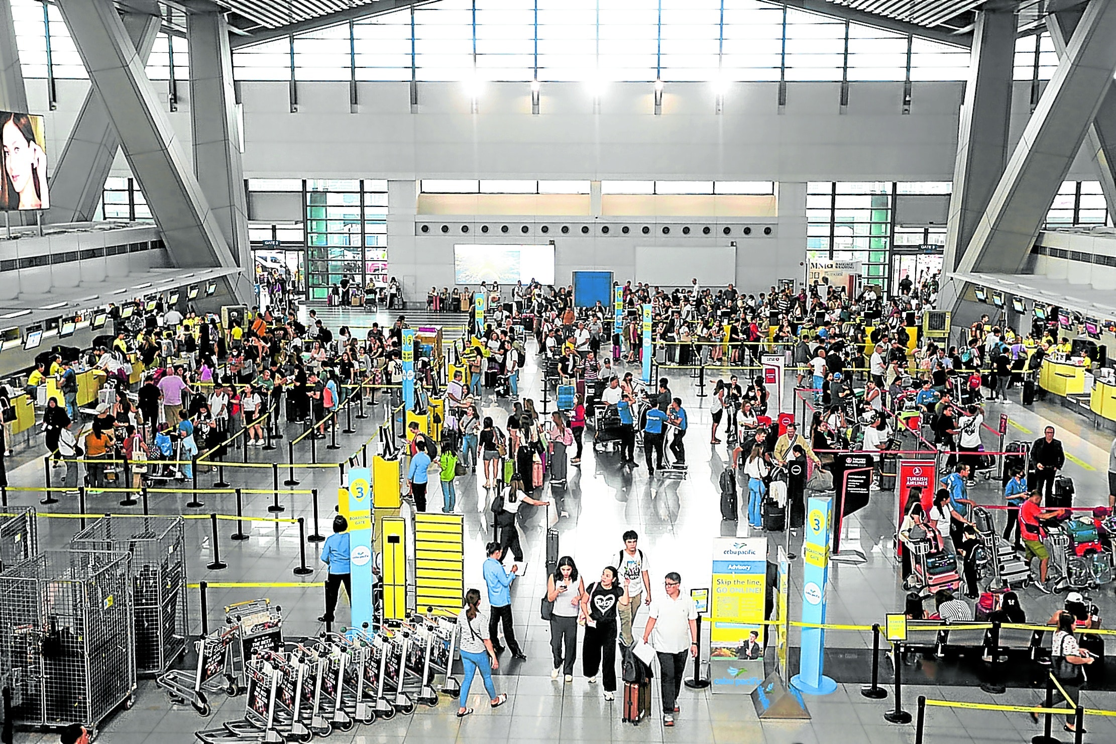 WAITING GAME Passengers flying out of Ninoy AquinoInternational Airport Terminal 3 may have to wait a while before bag handling goes back to normal. 