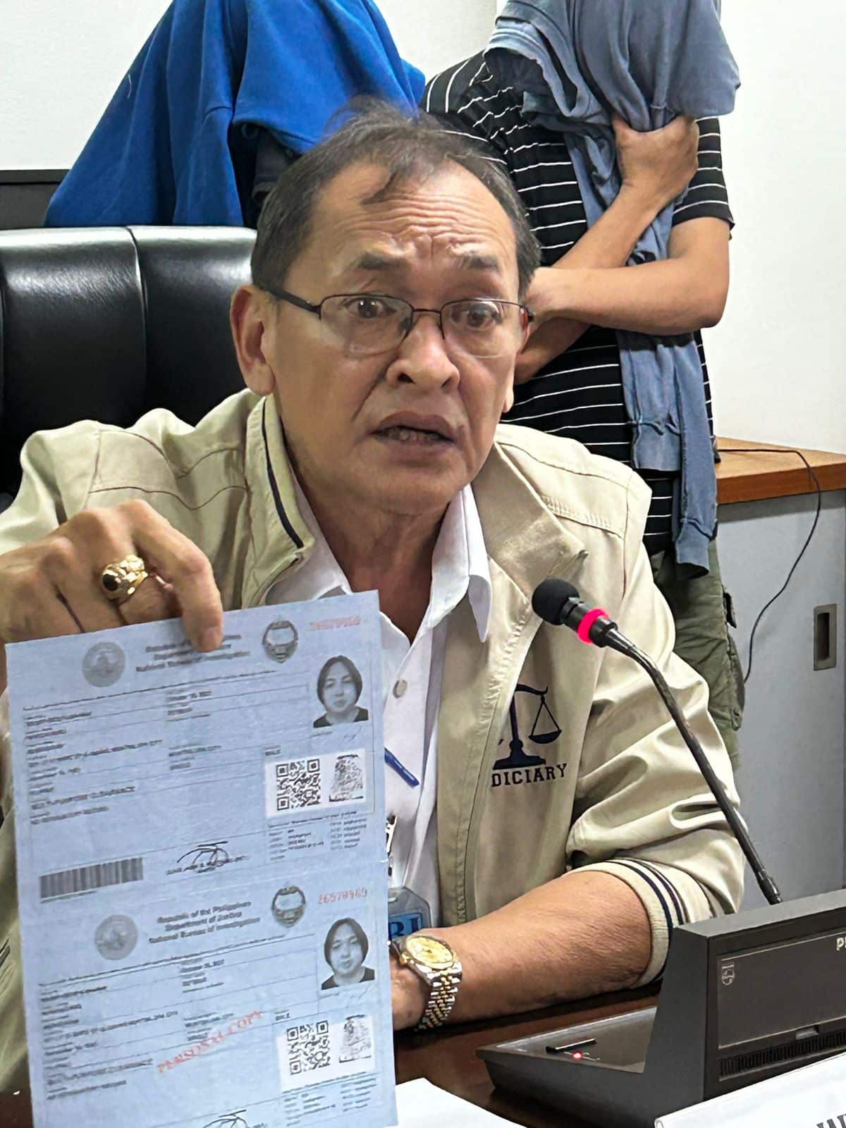 NBI Director Jaime Santiago presents to the media a fake NBI clearance recovered from a raid conducted in Sta. Cruz, Manila. The document, he said has no security marks but bears his own signature.