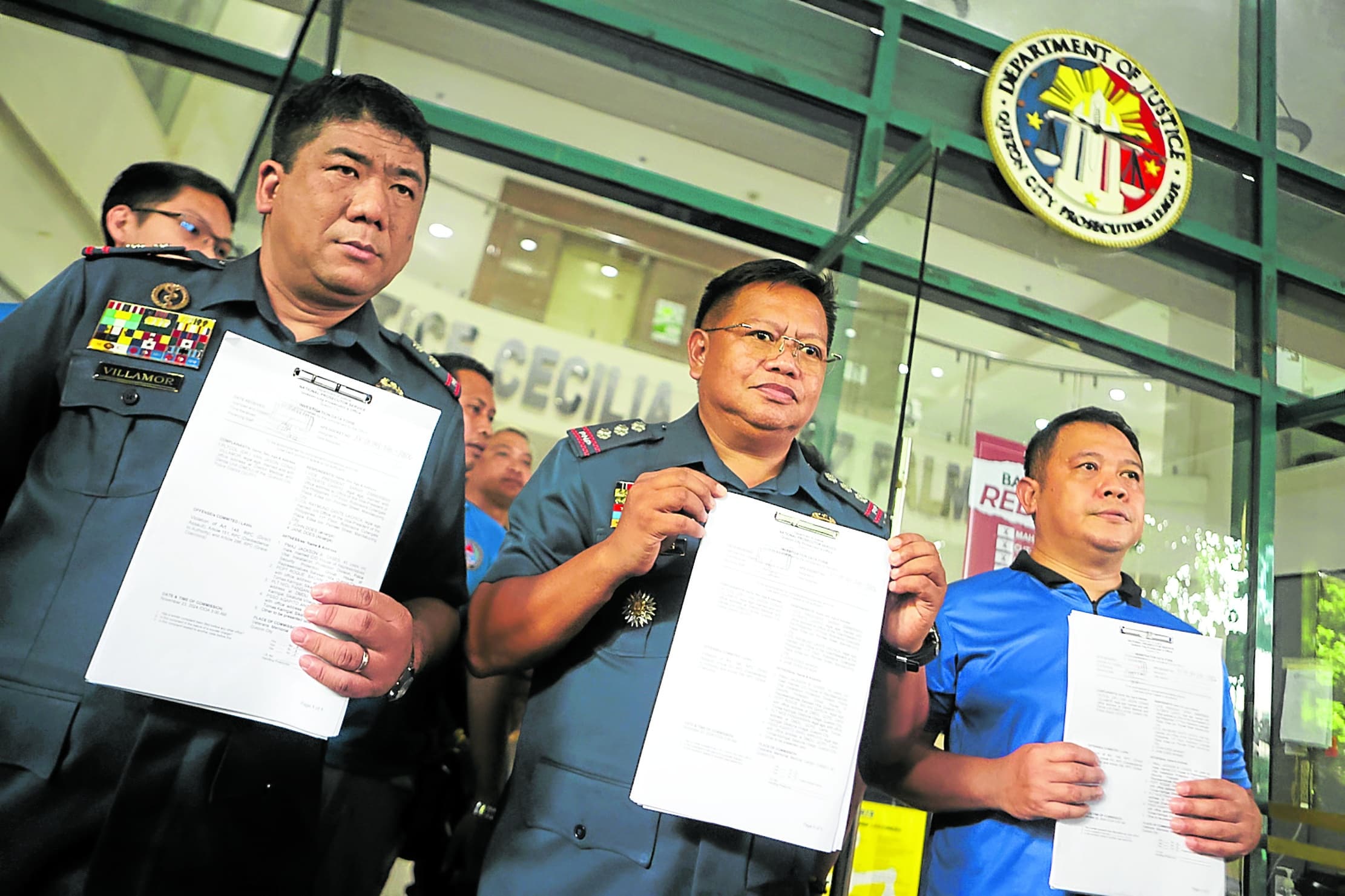 GOING AGAINST NO. 2 Acting Quezon City Police District (QCPD) Director Col. Melecio Buslig (center) accompanies QCPD medical and dental unit chief Lt. Col. Van Jason Villamor (left) in filing a complainton Wednesday against Vice President Sara Duterte and her staff for direct assault during last weekend’s tensions at the Batasang Pambansa and Veterans Memorial Medical Center. 