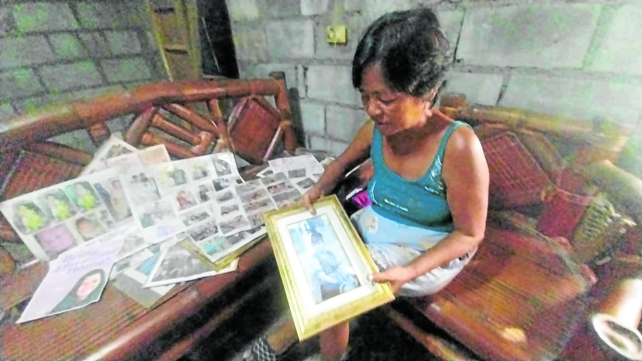 Mary Jane Veloso's mother Celia, at home in Gen. Natividad, Nueva Ecija, on Thursday scans her photos as the family anticipates her return to the Philippines. 