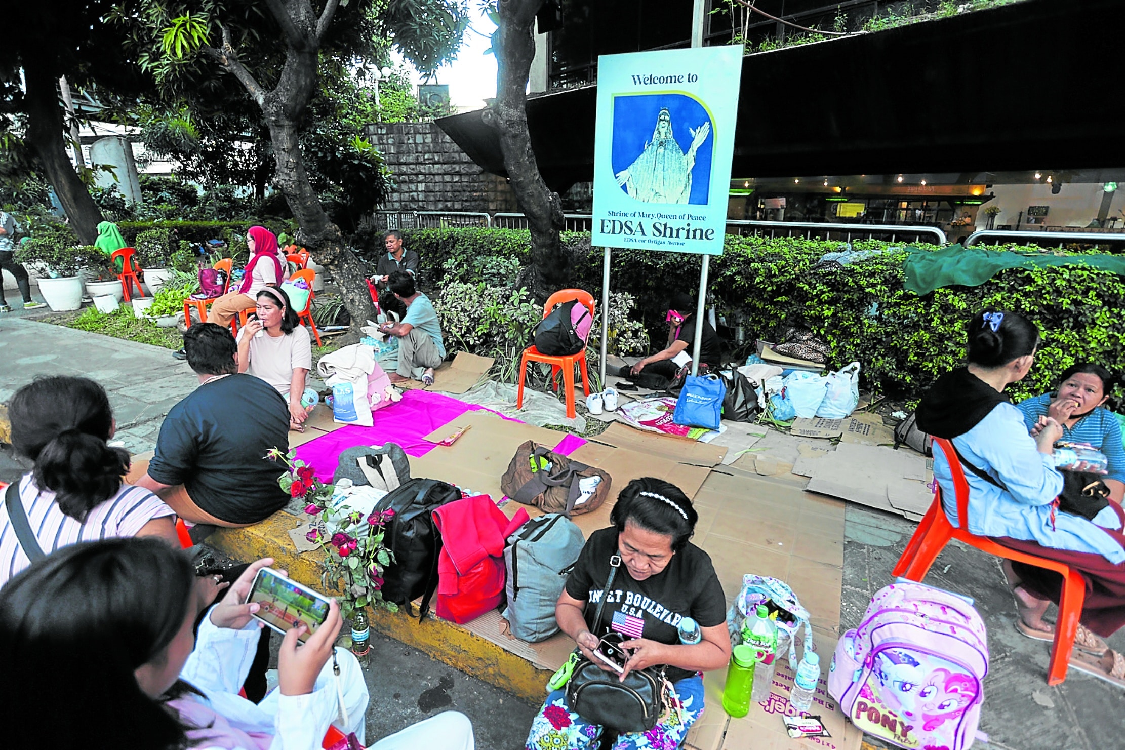 SHOW OF SUPPORT Since Monday, supporters of Vice PresidentSara Duterte have been gathering just outside Edsa Shrine in Quezon City. They numbered about a hundred, some of them shown here, when this photo was taken on Wednesday morning.