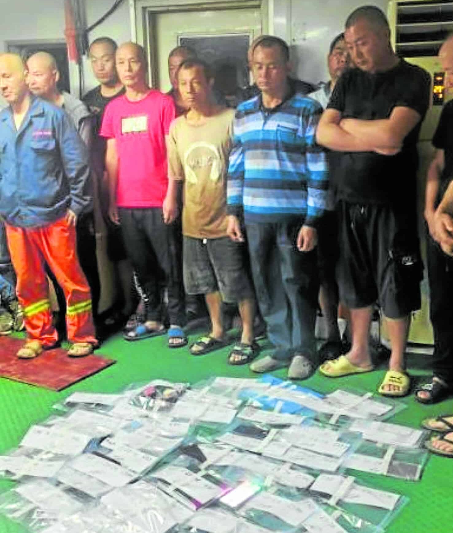 These undocumented Chinesenationals (right) have been arrested by the Philippine Coast Guard following an inspection of the dredger vessel Harvest 89 in Mariveles, Bataan on Tuesday.