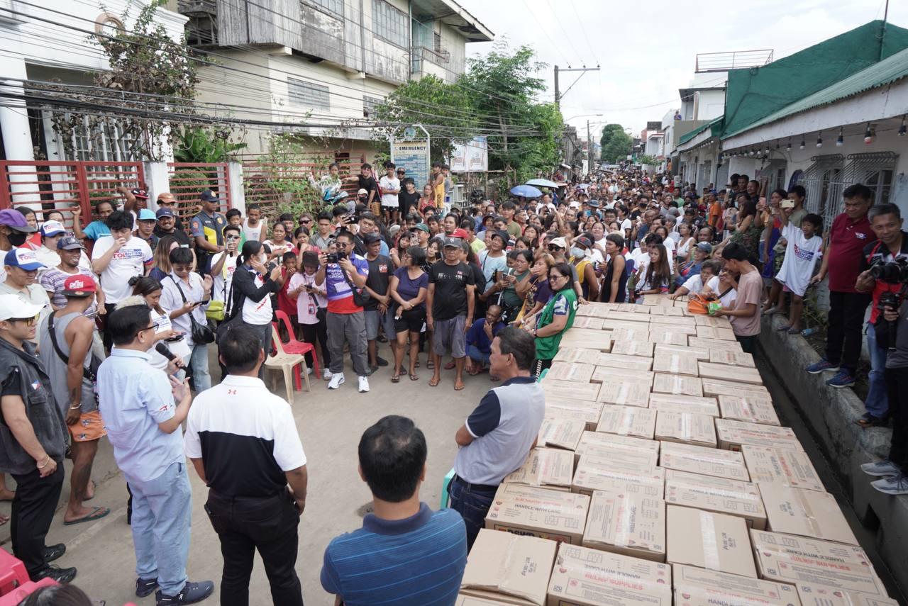 Senate Majority Leader Francis "Tol" Tolentino handing over boxes of relief goods to 7,241 families in the regions worst hit by the recent disaster.