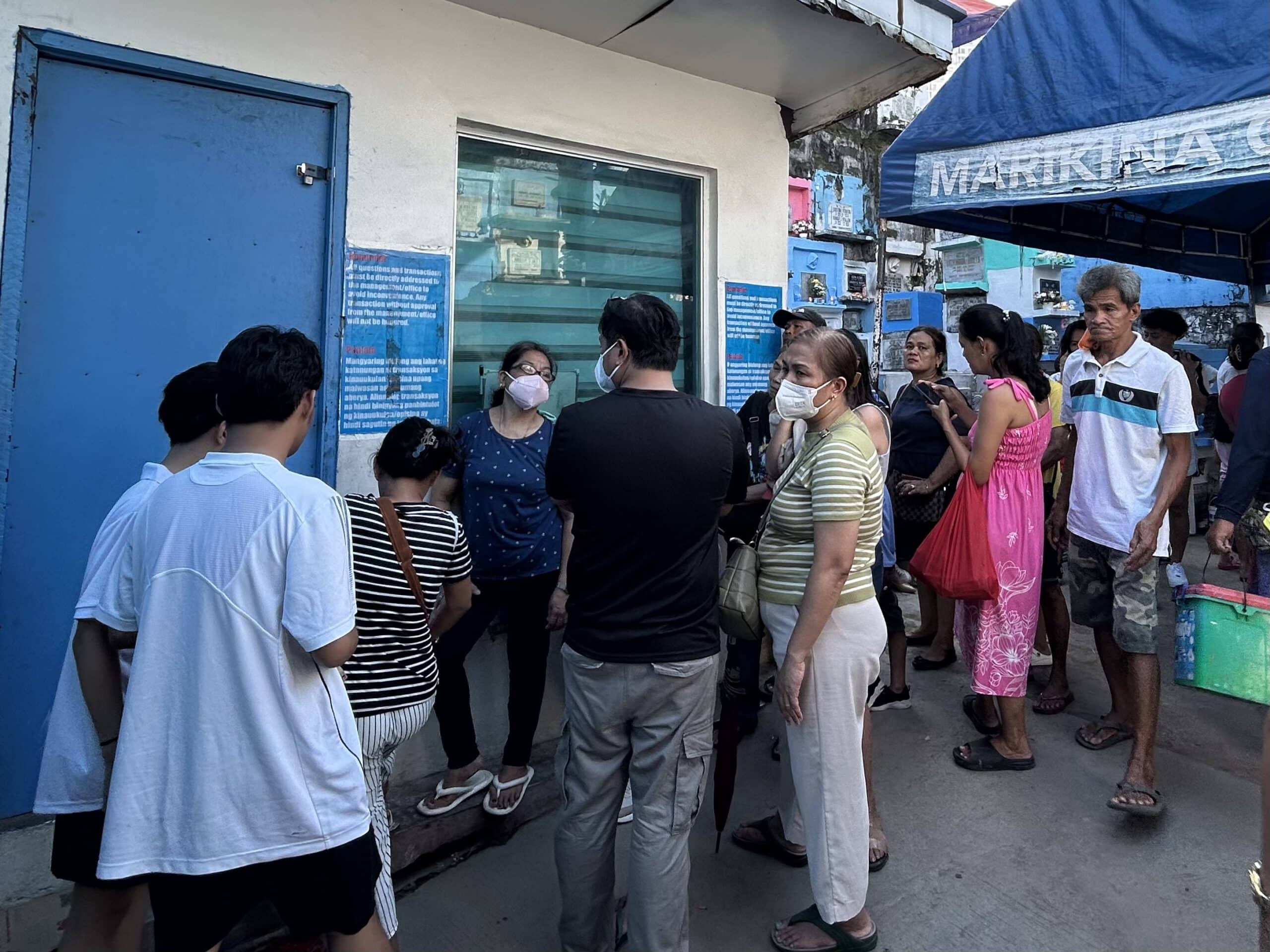 Family members of exhumed remains at Barangka Municipal Cemetery camp outside the administrative office on Friday, November 1 to raise concerns over unauthorized exhumations.