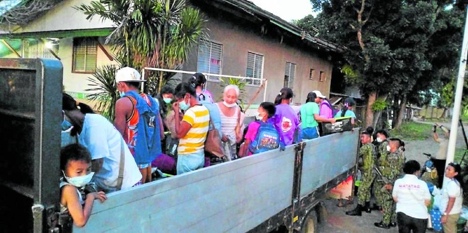 SAFETY FIRST Residents of Barangay Cabagnaan in La Castellana, Negros Occidental, are being evacuated to safer grounds after the eruption of Monday of Mt. Kanlaon.