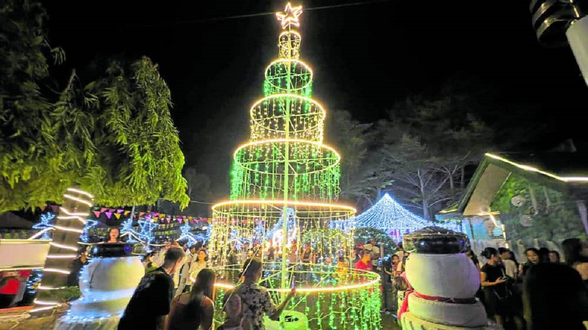 ALL LIGHTED UP - Residents of La Castellana, Negros Occidental welcome the Christmas lighting event at their town center on Monday night, which proceeded despite the continued threat posed by the restive Mt. Kanlaon.