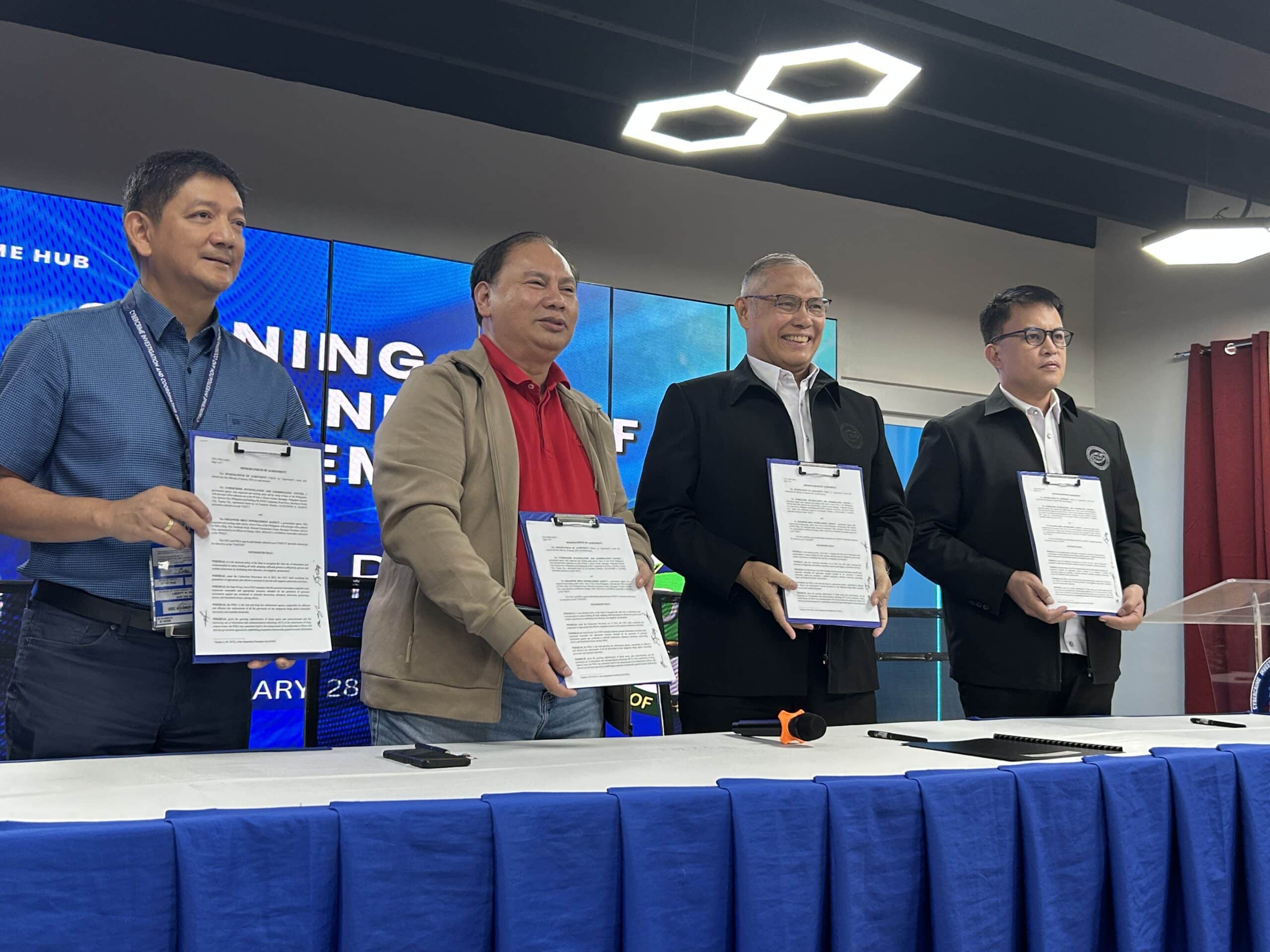 The Philippine Drug Enforcement Agency (PDEA) Deputy Director for Operations Renato Gumban (middle-right) and the Cybercrime Investigation and Coordinating Center (CICC) Executive Director Alexander Ramos (middle-left) sign an agreement for the two agencies to share expertise in the anti-illegal drug campaign in a ceremony at the National Cybercrime Hub in Taguig City on Tuesday, Jan. 28, 2025. 
