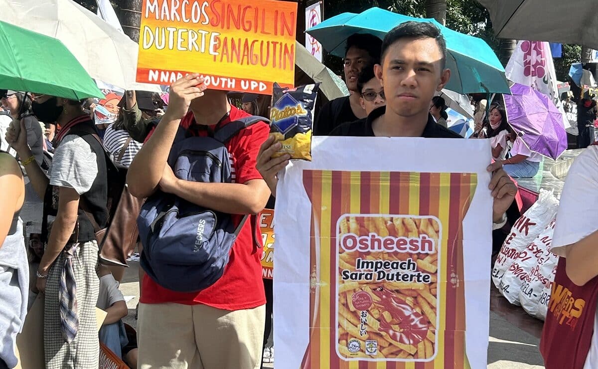 A protester holds placard and a popular potato chips whose brand name bears resemblance to the name used in alleged irregularities linked to Vice President Sara Duterte during the protest action calling for her impeachment in Liwasang Bonifacio in Manila on Jan. 31, 2025, Friday.