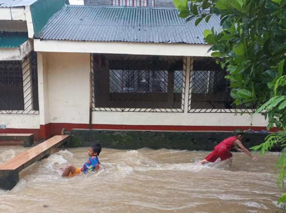 DIFFERENT PLAYGROUNDChildren play in flooded streets at Barangay Cabagñan West in Legazpi City in Albay on Wednesday. Heavy rains starting Tuesday triggered floods and landslides in different provinces in the Bicol region.