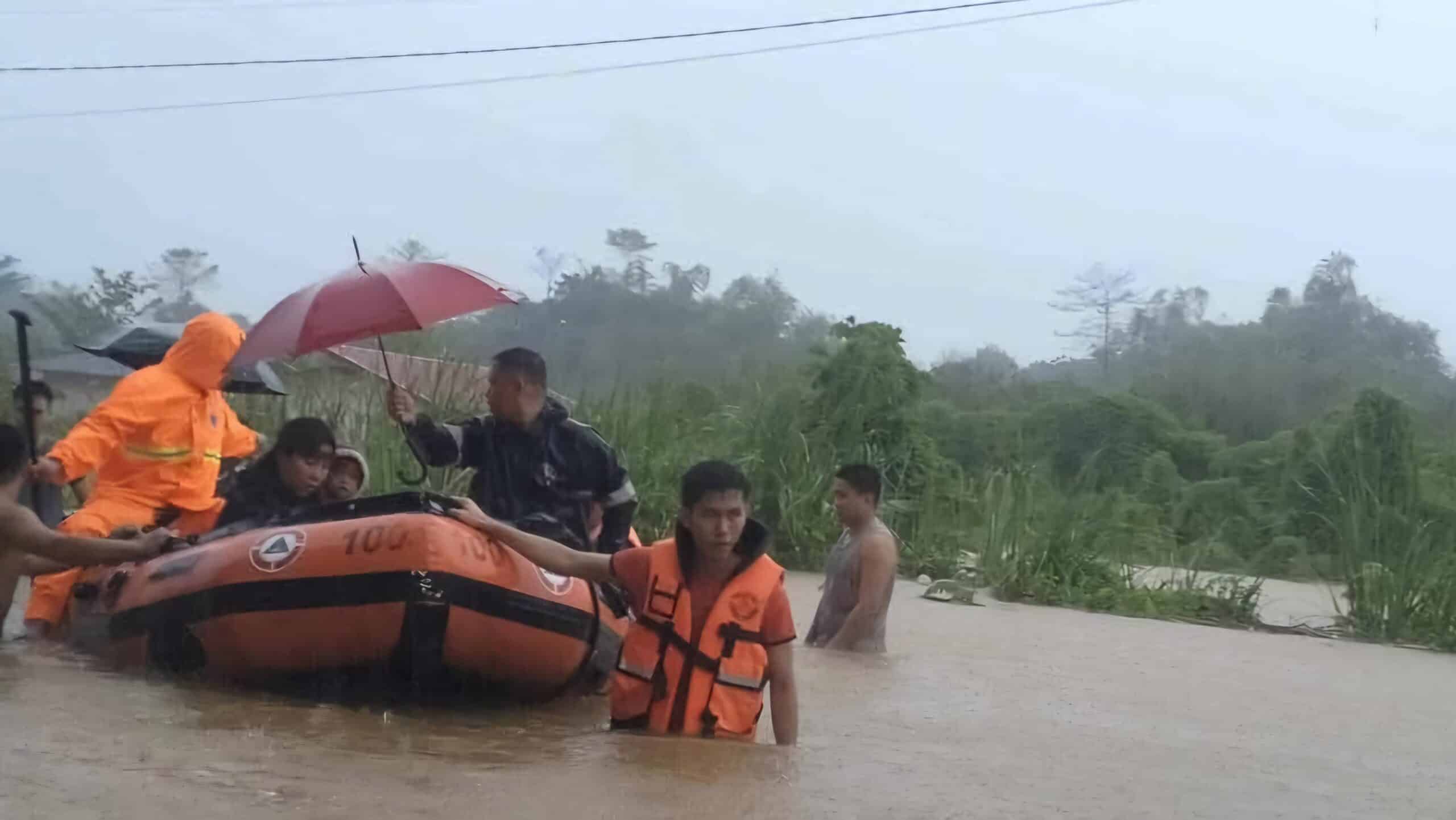 SAFETY IS PRIORITY Members of a government rescue teambrave rising floodwaters in Puerto Princesa City to bring residents to safer grounds.