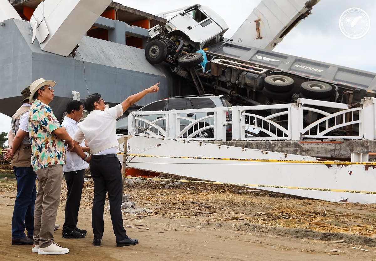 DESIGN FLAW President Marcos points to a part of the section of the Cabagan-Santa Maria Bridge in Isabela province on Thursday. He said cost-cutting led to the poor and flawed design resultingin the bridge collapse on Feb. 27, injuring eight people and damaging several vehicles. He vowed to find those responsible for the damage. 