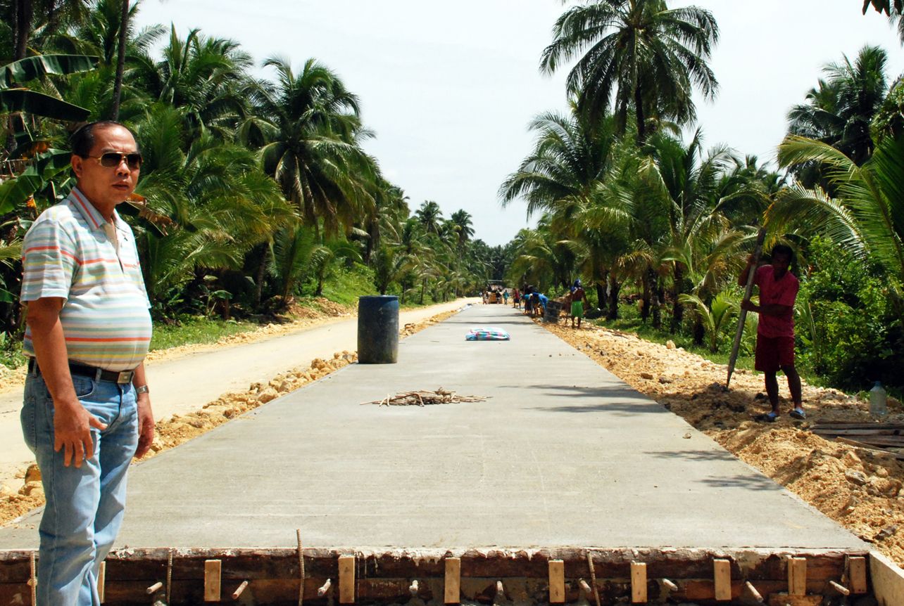Cong. Lalo Matugas oversees the concreting of Siargao’s 162 km circumferential highway which he completed in histhree terms as Congressman.