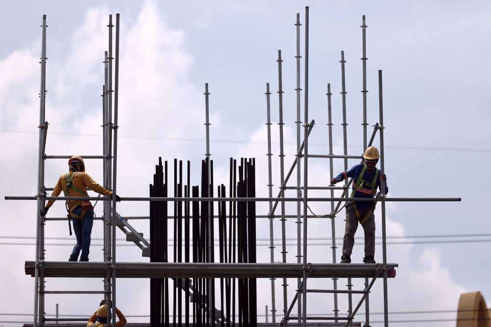 Construction workers hustle in the heat of the sun to accomplish a day's load of work at the MRT-7 railway project along Commonwealth Avenue in Quezon City on Thursday, July 28, 2022. —GRIG C. MONTEGRANDE