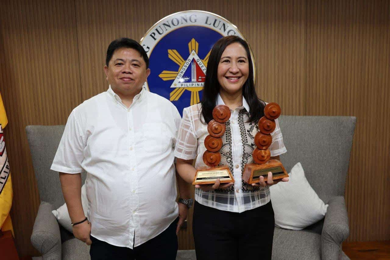 2. Belmonte sharing the award with Engelbert Apostol , head of QC PAISD.