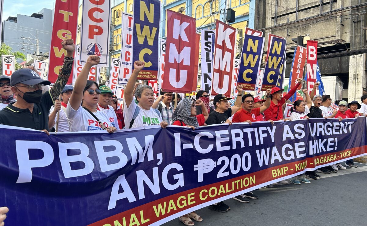 Members of various labor and progressive groups march along Espa&ntilde;a Boulevard in Manila to mark Labor Day on Thursday, calling on the government to implement a P200 increase in daily wage rates. &mdash; Photo by Faith Argosino/INQUIRER.net