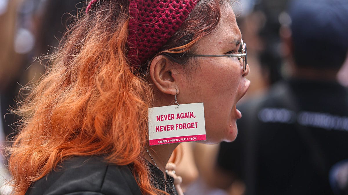 NEVER AGAIN A member of the Gabriela Women’s Party Bicol, wears on her ear her message as she joins Sunday’s rally in Legazpi City, Albay, denouncing corruption in government and marking the 53rd anniversary of the declaration of martial law. —MARK ALVIC ESPLANA