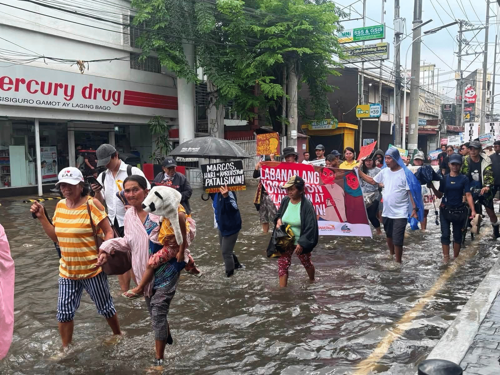 Bulacan residents wade through floods to protest flood-control corruption