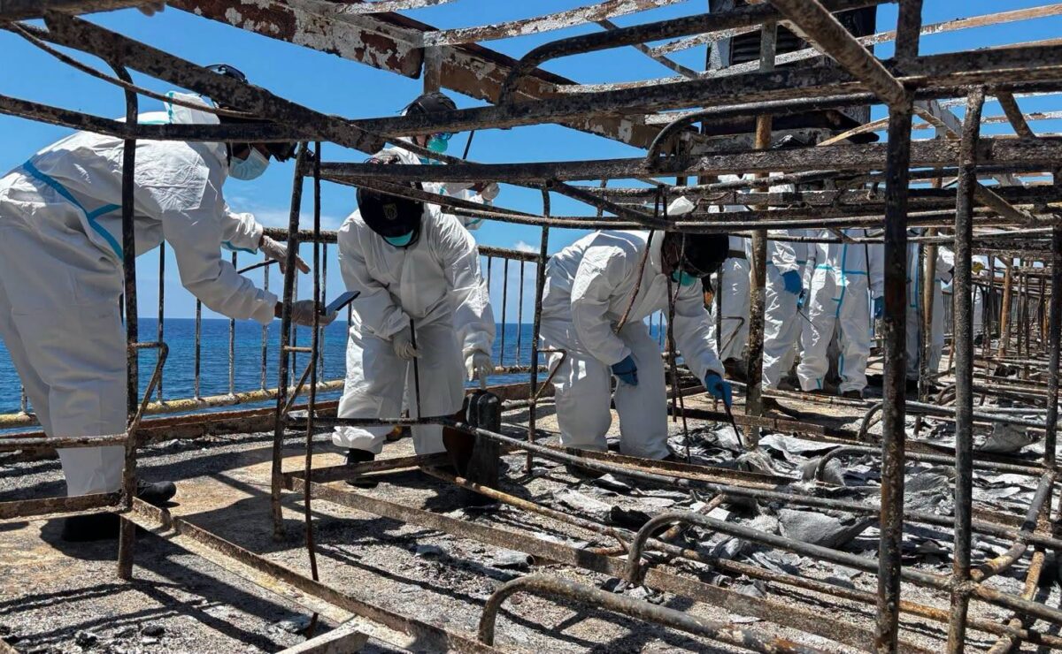 RECOVERY OPERATION Forensic personnel from the Philippine Coast Guard collect samples from the charred remains aboard MV June Aster during a recovery operation on Tuesday, the deadly fire that hit the vessel on Sept. 9.