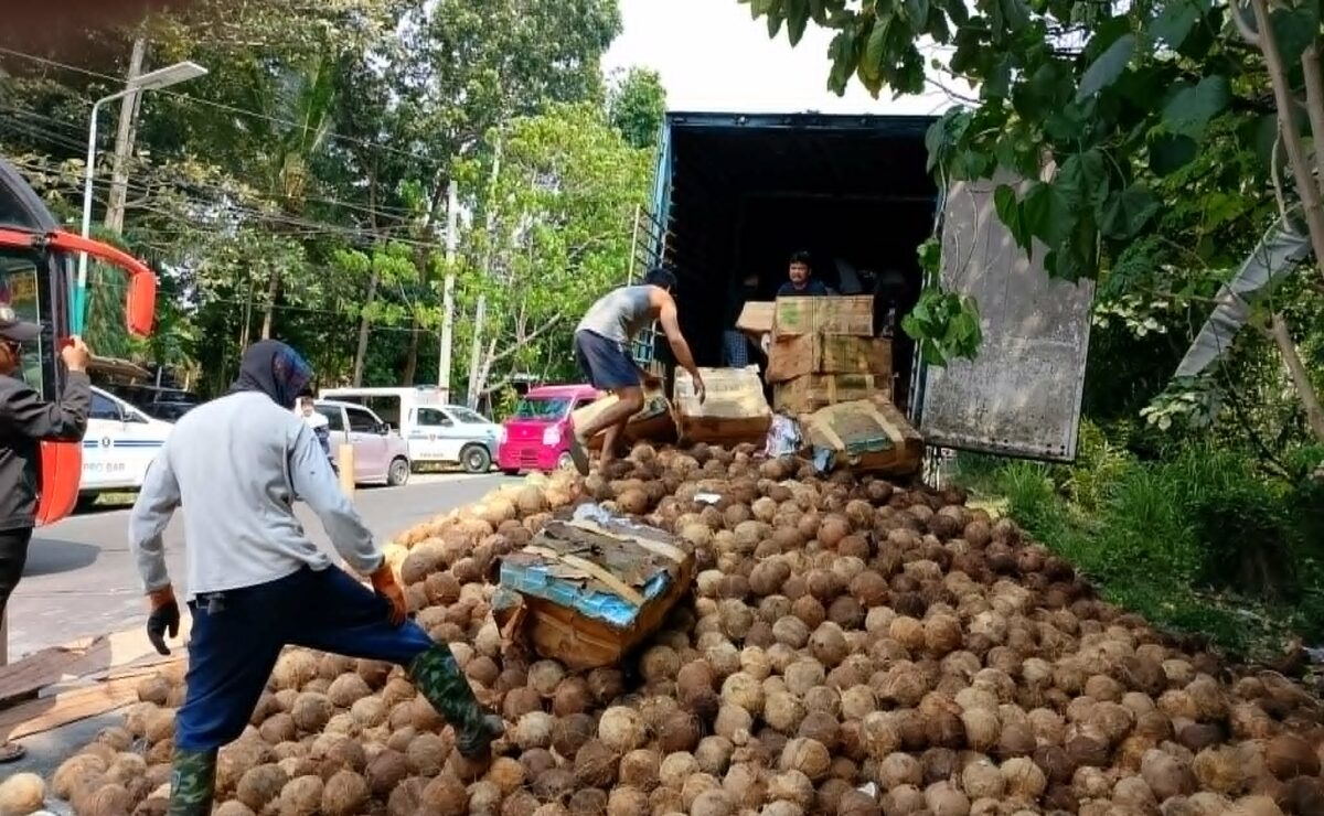 Police volunteers unload boxes of suspected smuggled cigarettes seized from a cargo truck loaded with coconuts in Parang, Maguindanao del Norte.