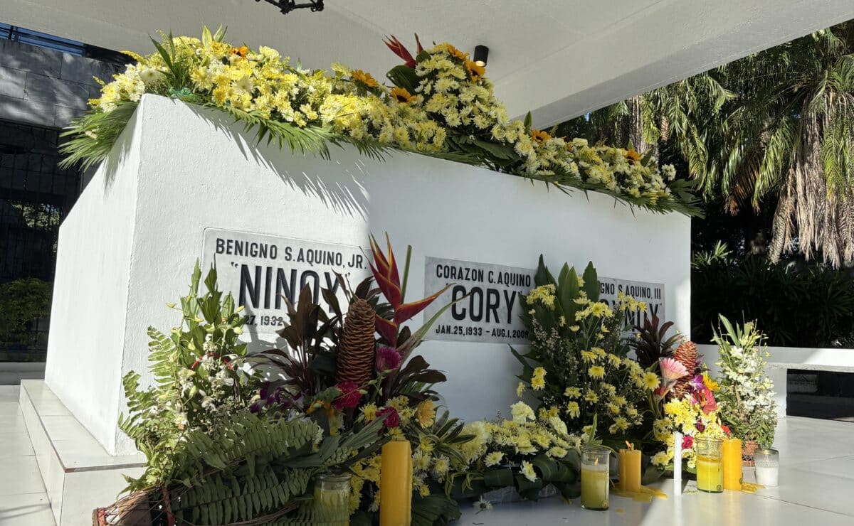 Flowers and candles adorn the tomb of the Aquinos on Oct. 30.