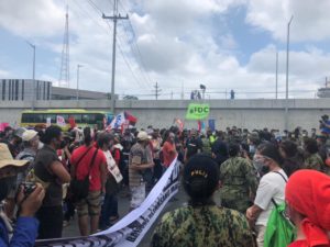Protesters facing off members of the police force managing the peace and order along Commonwealth Avenue leading to the Batasan Pambansa in Quezon City where President Rodrigo Duterte will hold his last and final State of the Nation Address.