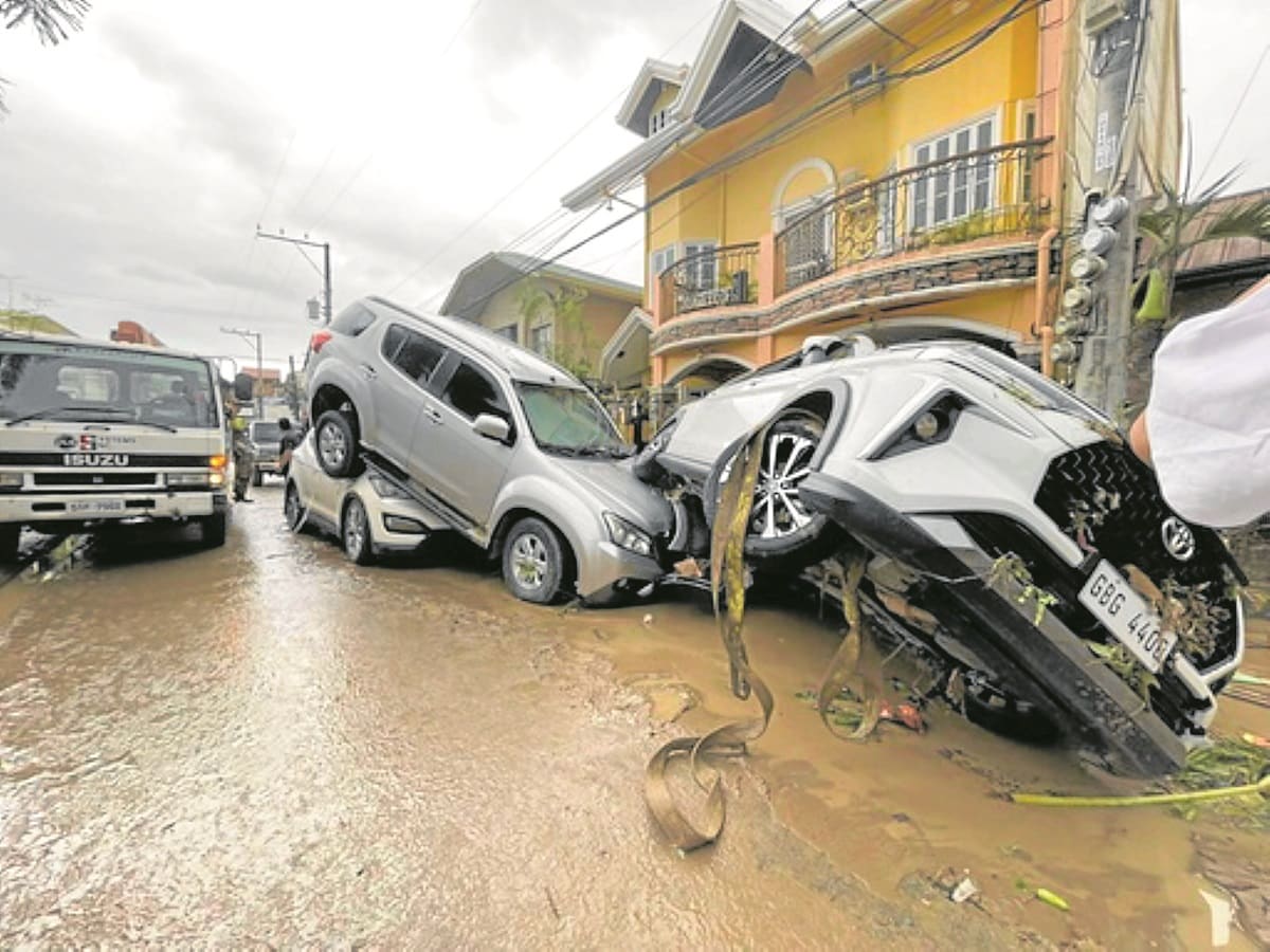 Tino floods leave cars in piles, trap families on rooftops